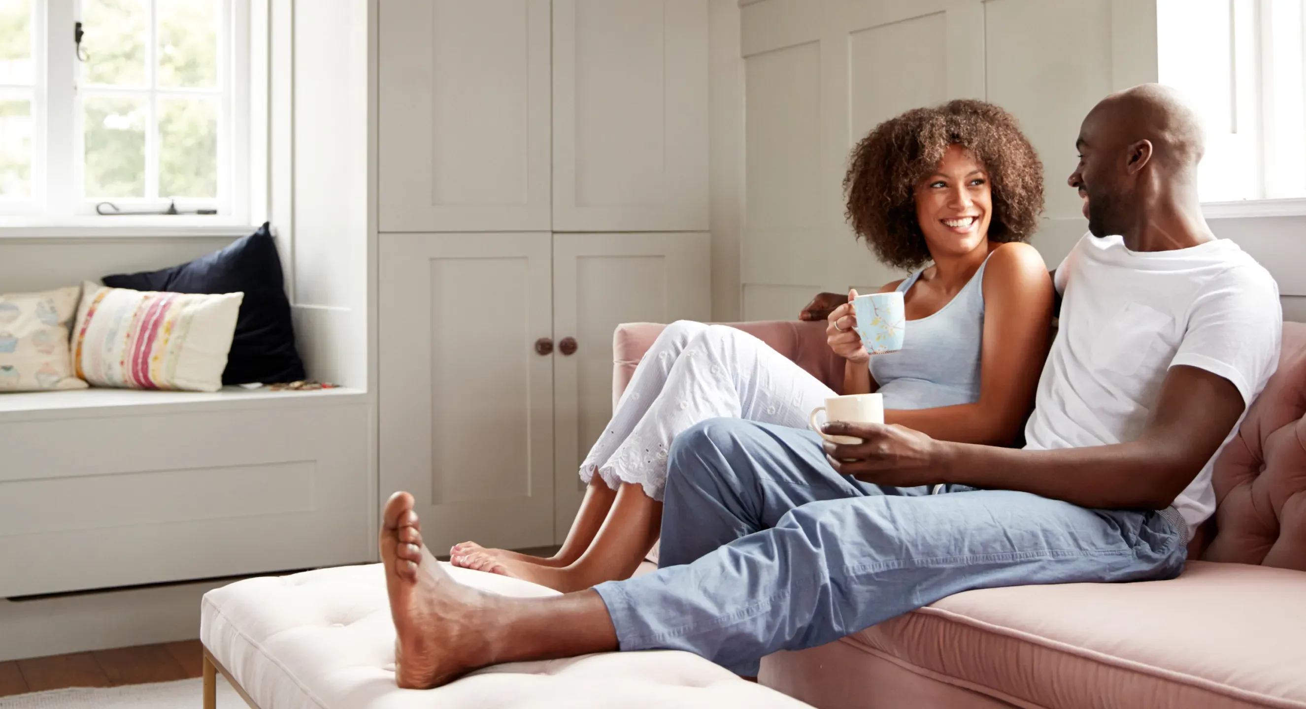 Couple relaxing barefoot at home, enjoying pain-free mobility and comfort
